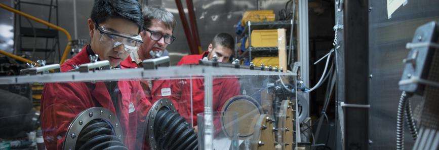 Two people in a mechanical lab.