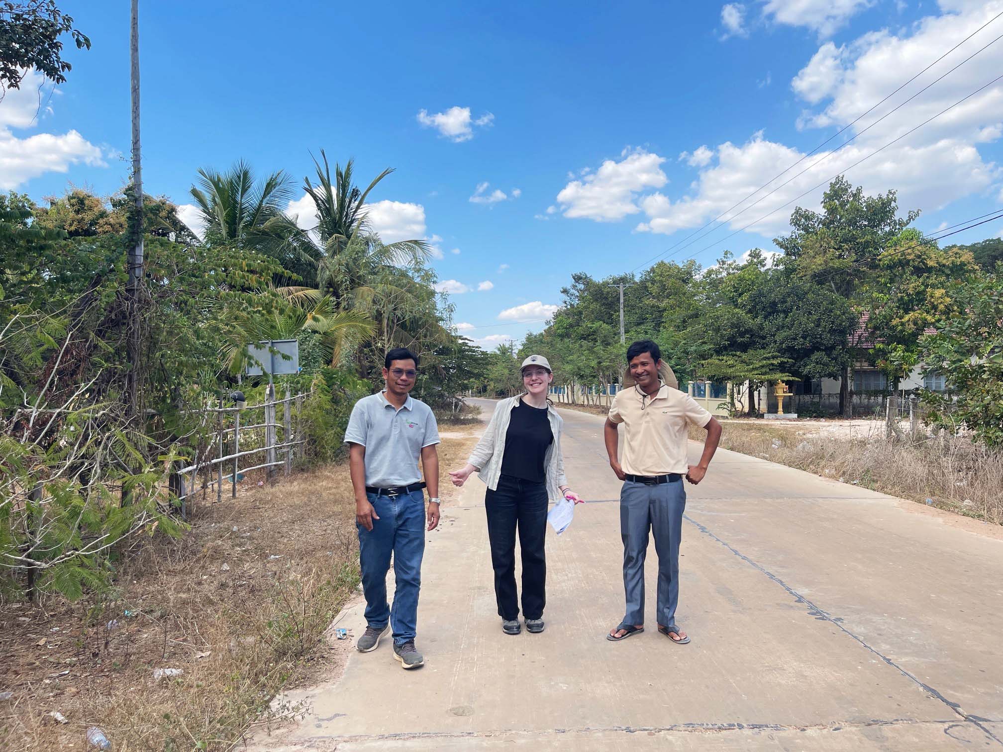 UBC Science Co-op student Ellen Brisley and two other folks on a road in Cambodia.