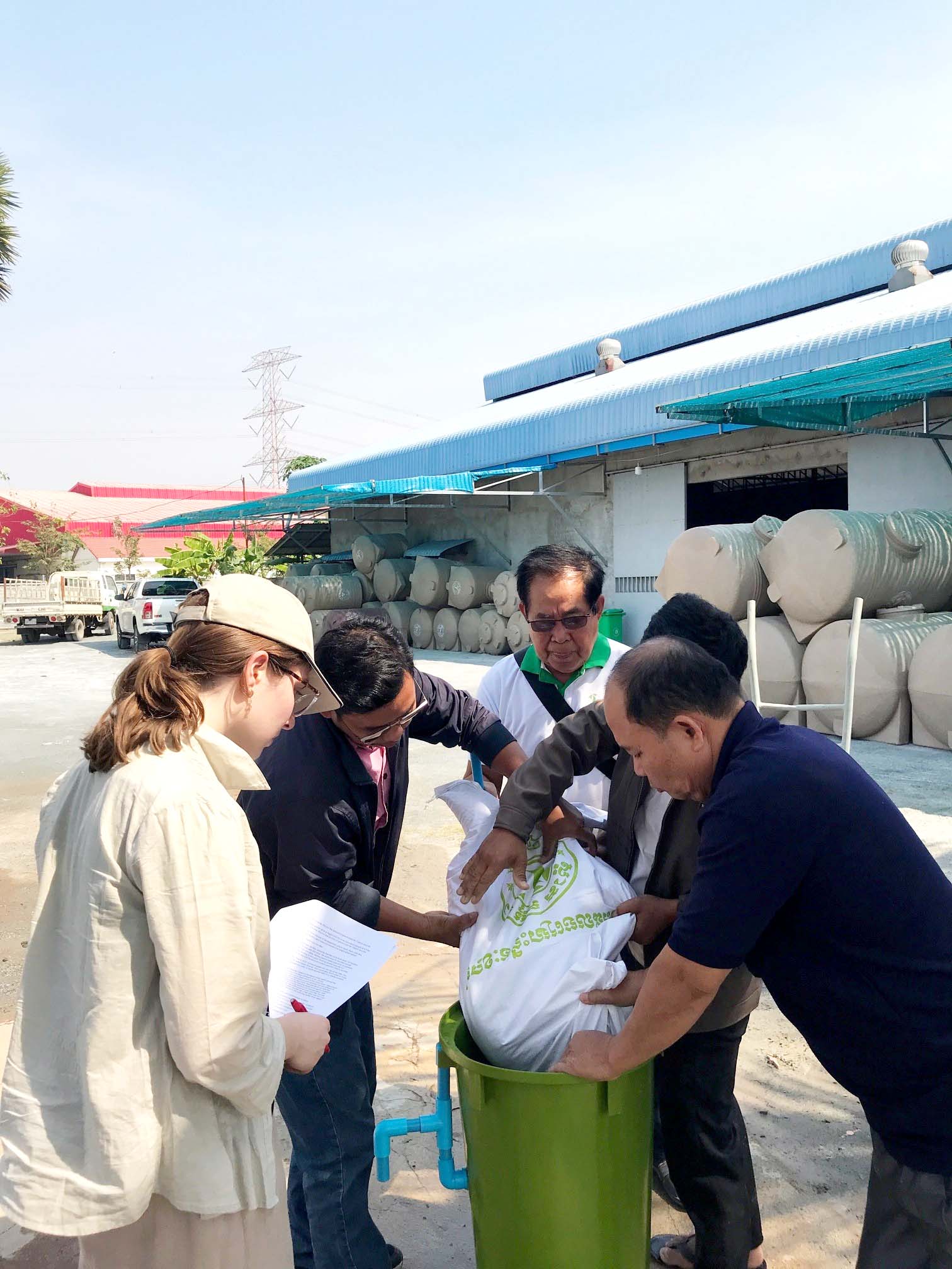 UBC Science Co-op student Ellen Brisley and Cambodian folks assemble a BioSand filter together.