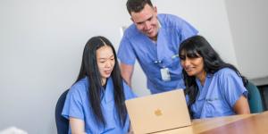 A supervisor mentors two medical students.