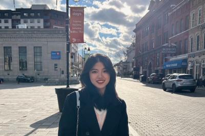 UBC Science Co-op student Jiahe Jiang stands on a street in the sunlight.