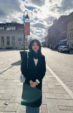 UBC Science Co-op student Jiahe Jiang stands on a street in the sunlight.