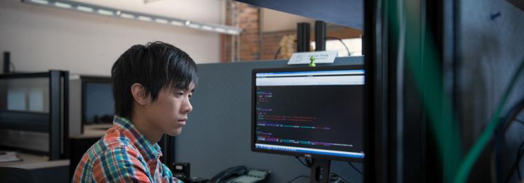 A student works at a computer.