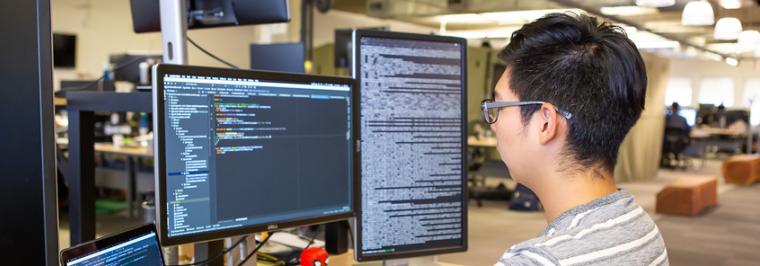 A man looks at a computer.