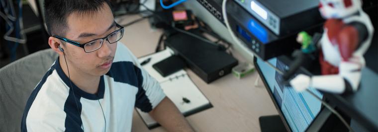 A man sits at a computer.