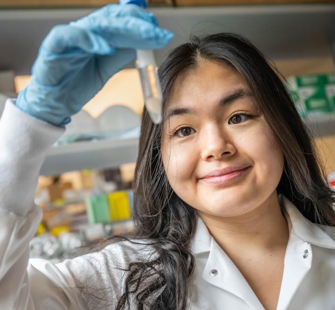 A student holds up a test tube.